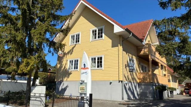 a large yellow house with a white garage at Haus Stoertebeker Appartements - Hotel Garni, Seebad Lubmin in Lubmin
