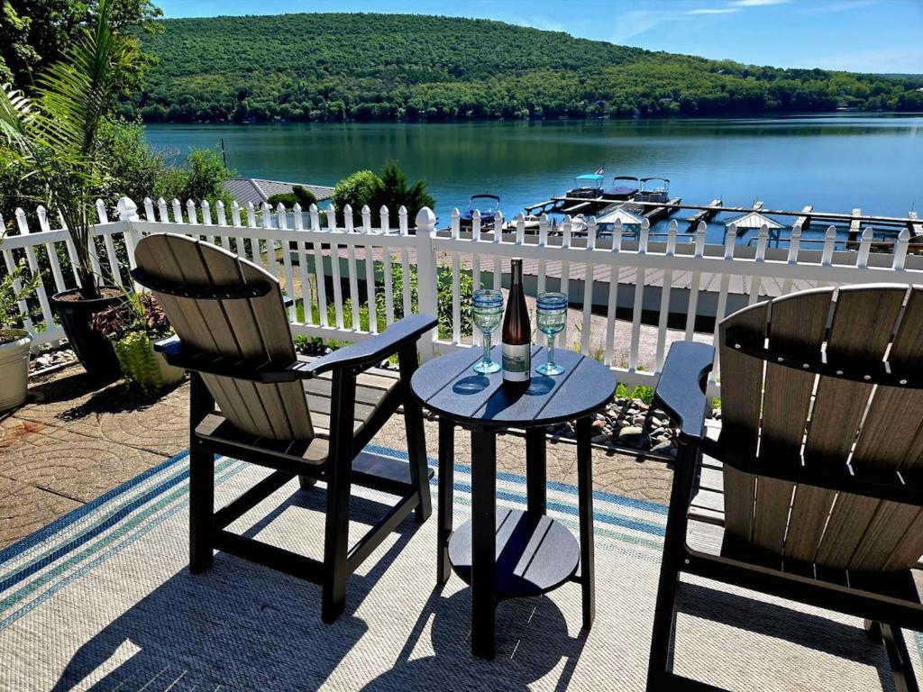 two chairs and a table with a bottle of wine at The View at Harbor Lights in Hammondsport