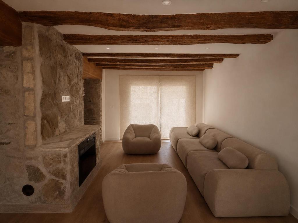 a living room with a couch and a television at Jaca Stone in Banaguás