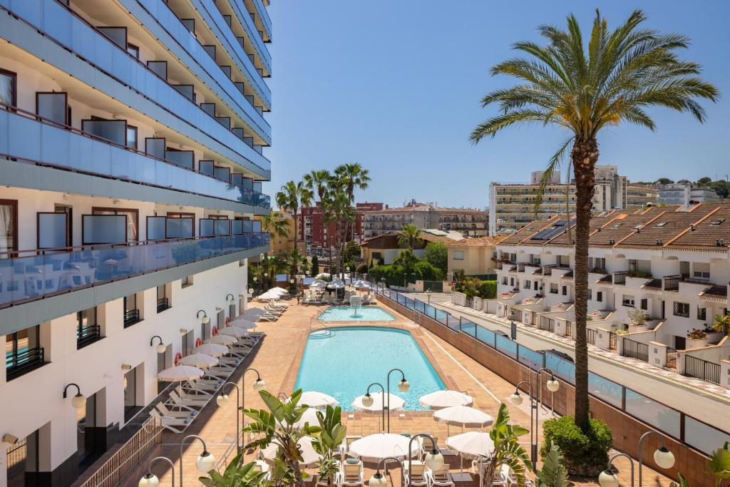arial view of a hotel with a pool and palm trees at htop Jadhe SPA 4Sup - Bliss in Calella