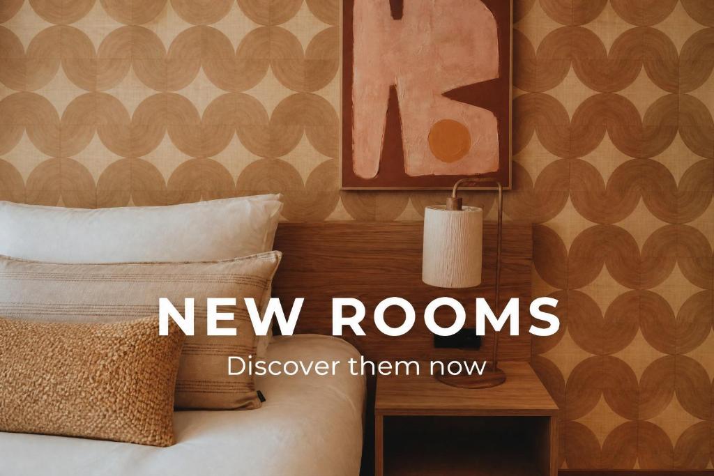 a bedroom with a bed with a new rooms sign at Van der Valk Hotel Gent-Drongen in Ghent