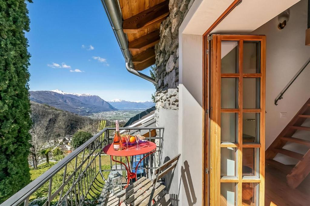 a balcony with a table with drinks on it at Mille Colline la Casa 1 with Shared Pool - Happy Rentals in Pianezzo
