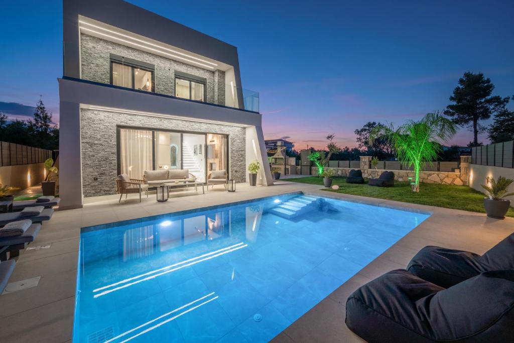 a swimming pool in the backyard of a house at SunWhite Villas - Private Pool & Cozy Atmosphere, by ZanteWize in Laganas