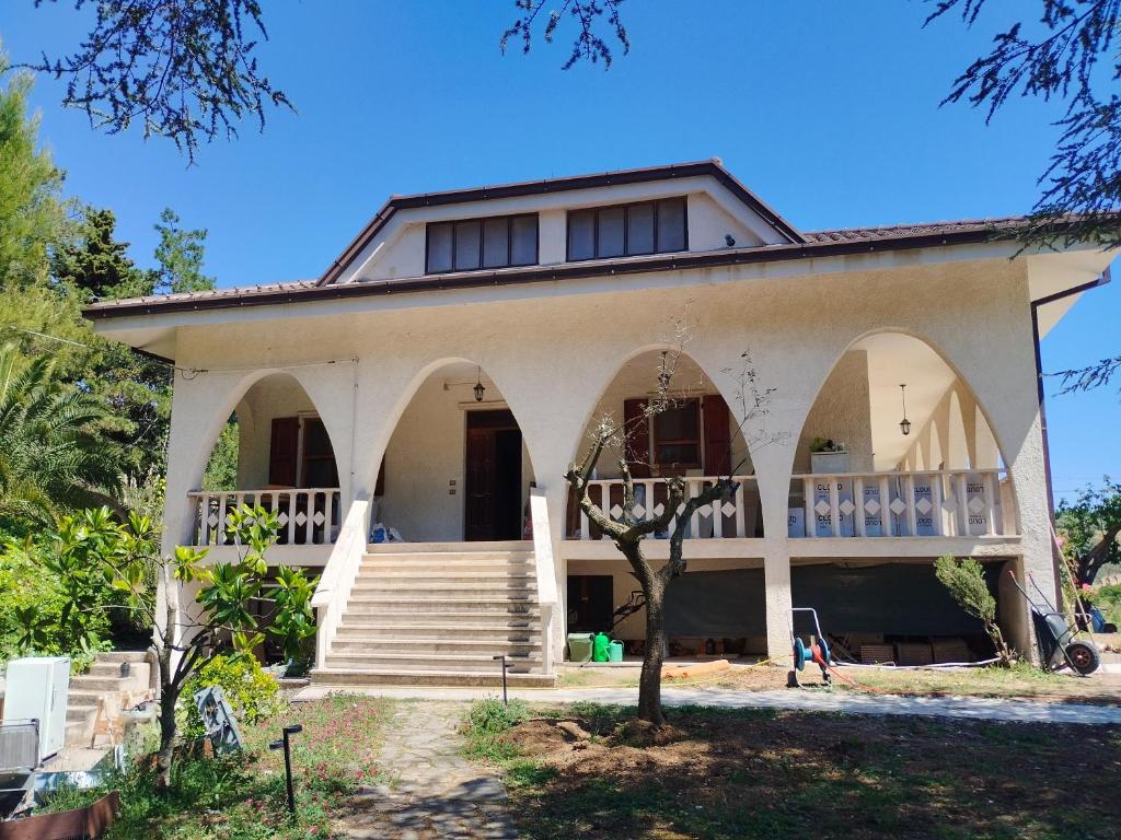 a house with arches and stairs in front of it at Country House Villa Marezi in Cupra Marittima