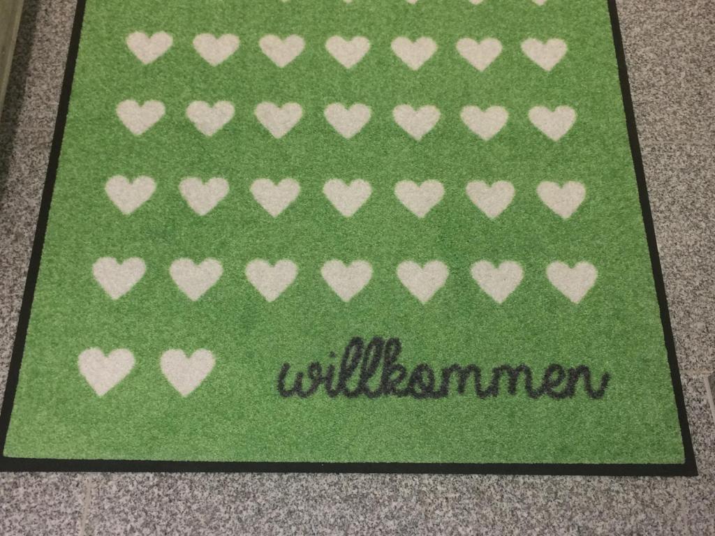 eine grüne Karte mit weißen Herzen und das Wort willuminati in der Unterkunft Apartment Deluxe Baden-Baden in Baden-Baden