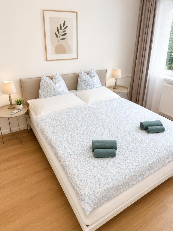 a bedroom with a large bed with two pillows on it at VeloVibe apartman in Balatonalmádi