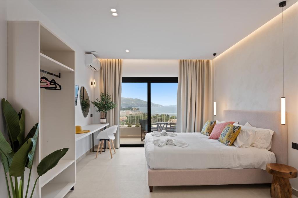 a bedroom with a bed and a desk with a view at Giorgos apartments in Dassia
