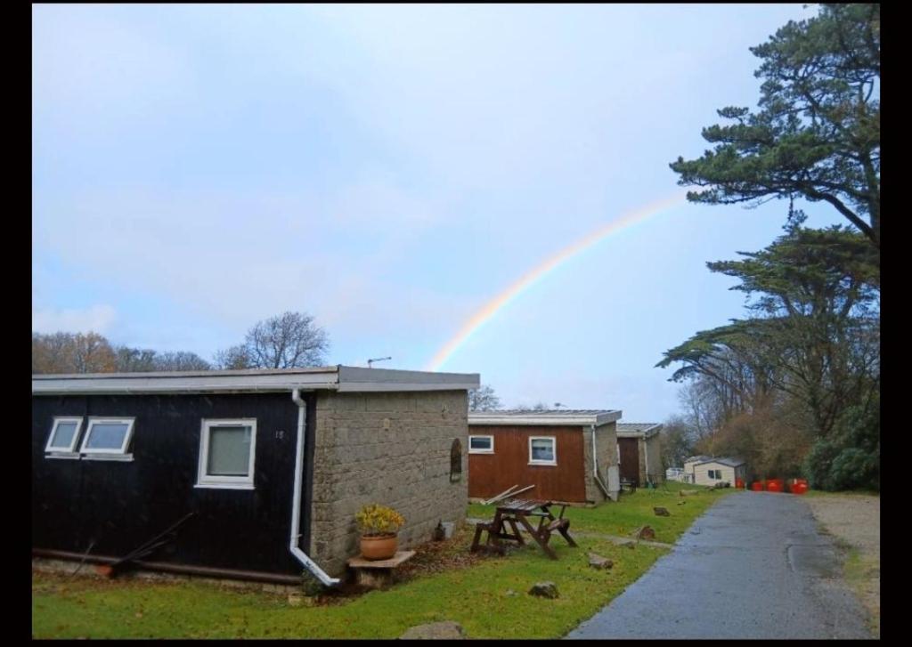 a rainbow in the sky over a house at Bucklands - Chalet 15 in Westward Ho