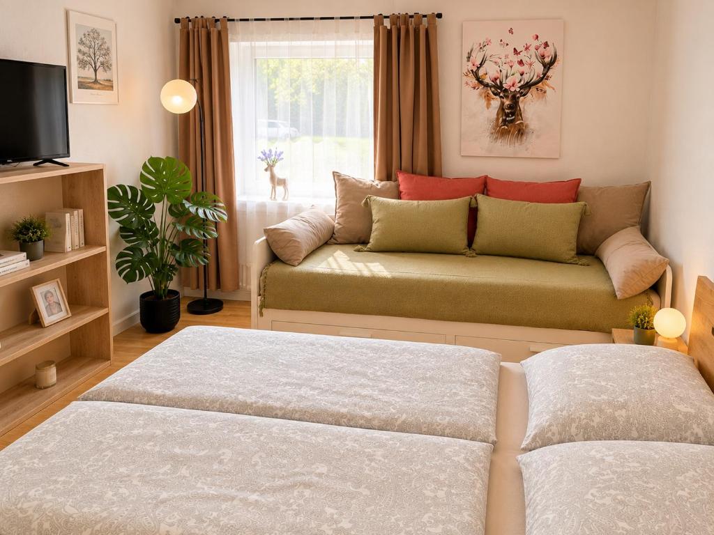 a living room with a couch and a window at Schwarzwaldliebe mit Garten & Sauna in Gaggenau