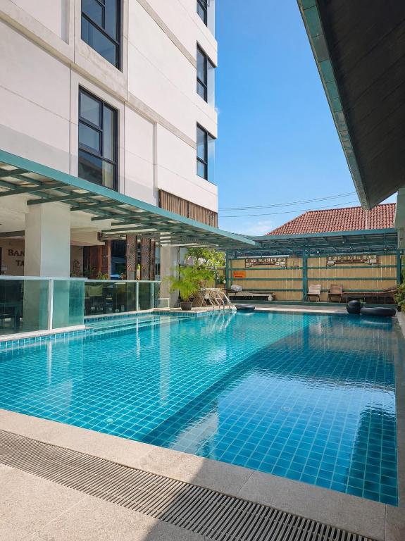 a large swimming pool next to a building at Baan Tanwa - MRT Ratchadapisek Exit 1 or 2 in Bangkok