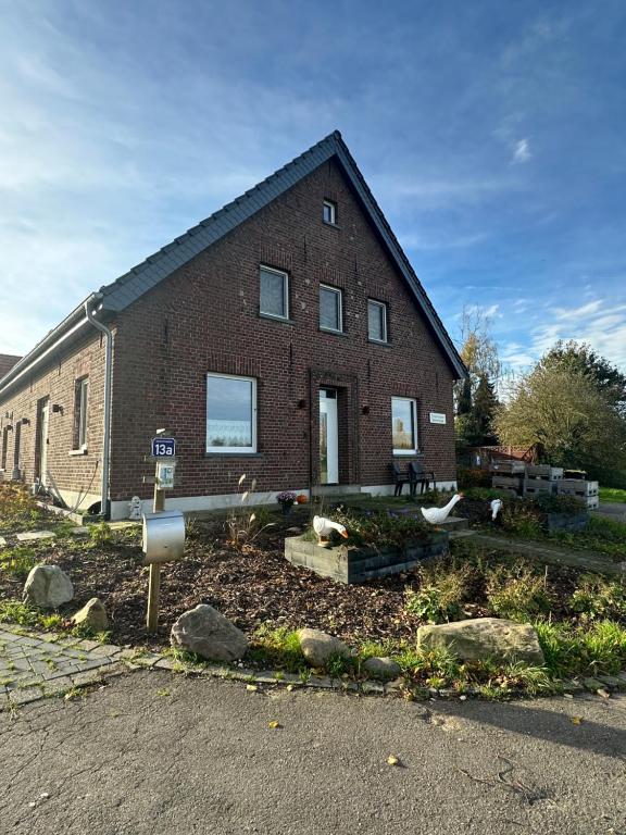 a brick house with a sign in front of it at Fewo Snowdogs in Goch