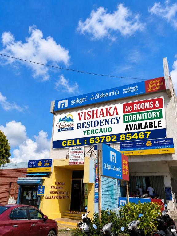 a building with signs on the side of it at VISHAKA RESIDENCY yercaud in Siddhma