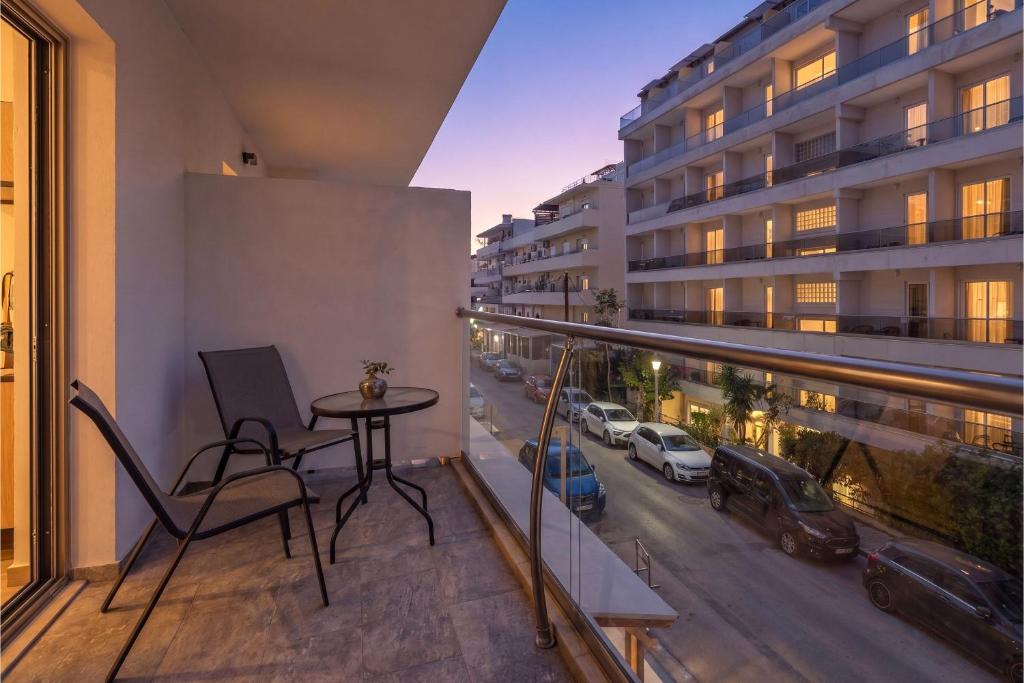 a balcony with a table and a view of a city at Santa Maria City Hotel in Rhodes Town