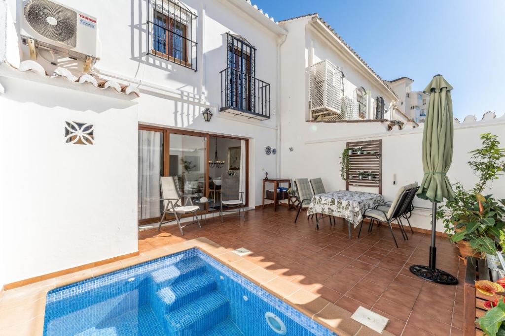 a villa with a swimming pool and a house at Casa Pueblo Lopez in Fuengirola