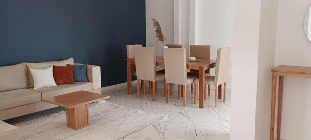 a living room with a couch and a table at Apartement Rimsou in Kelibia