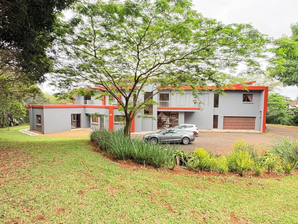 a house with a car parked in front of it at Mabee's Place in Durban