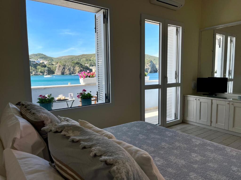 a bedroom with a large window with a view of the ocean at Villa Marisa - La Guarida in Ponza