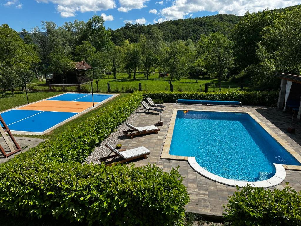 an overhead view of a swimming pool with chairs and a basketball court at Holiday Home Faruk in Račić