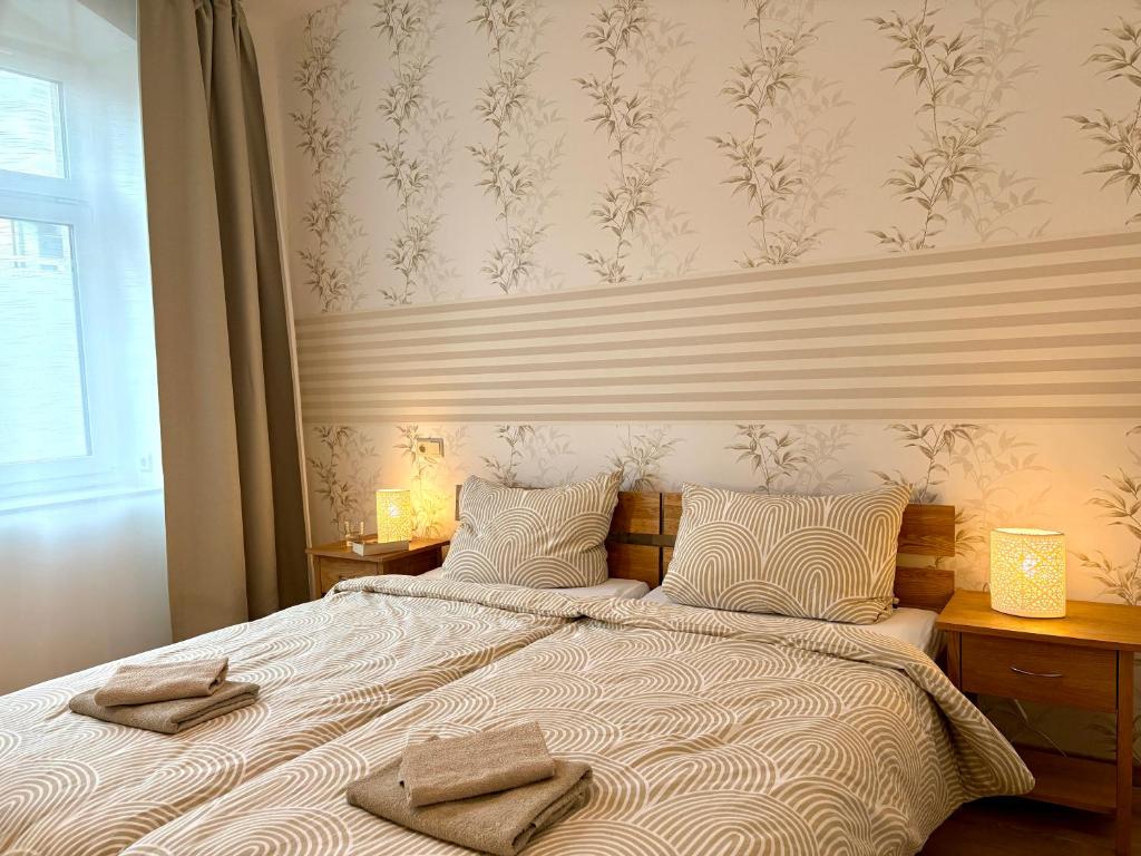 a bedroom with a bed with two towels on it at Ferienwohnungen Landeskrone Dresden in Dresden