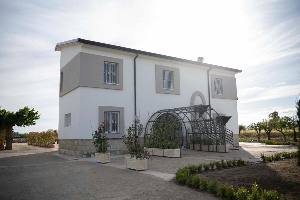 a white building with a gate in front of it at Relais Terramare in Cellole