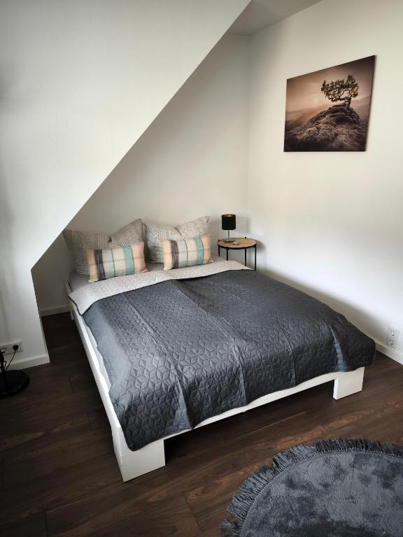 a bedroom with a bed in a white room at Ferienwohnung Weyer in Villmar