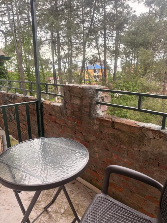 a table and chairs on a balcony with a view at ძველი სახლი Old house in Ureki