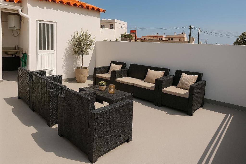 a patio with two couches and a table at Oramas Secret Cellar – Casa Rural in Arico