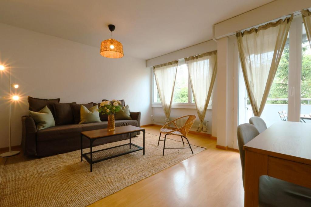 a living room with a couch and a table at Cozy Apartment with Easy Access to Bern in Bern