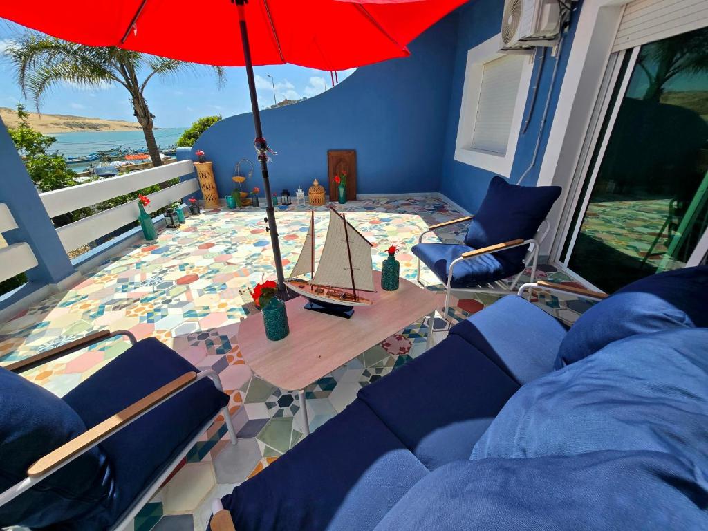 a living room with a table with a model boat on it at lagoon apartment 2 in Moulay Bousselham