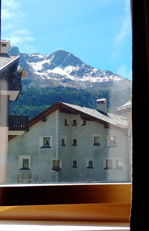 a view of a building with a mountain in the background at Studio in St Moritz Champfer in St. Moritz