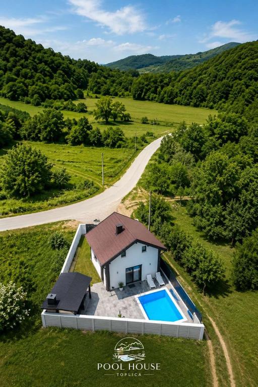 an overhead view of a house with a swimming pool and a road at Pool House in Toplica