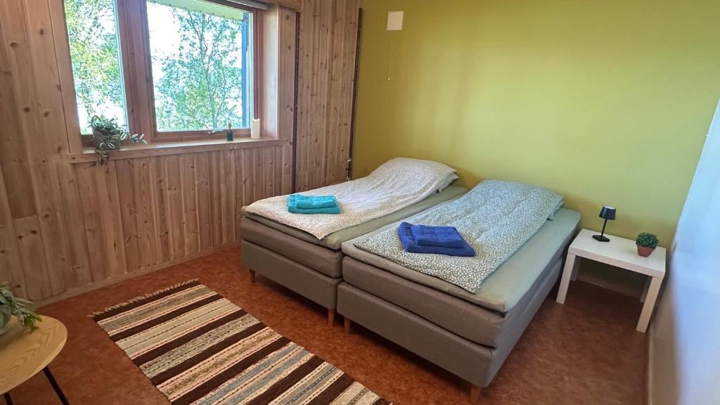 a small bedroom with a bed and a window at Comfortable B&B near Senja in Brostadbotn