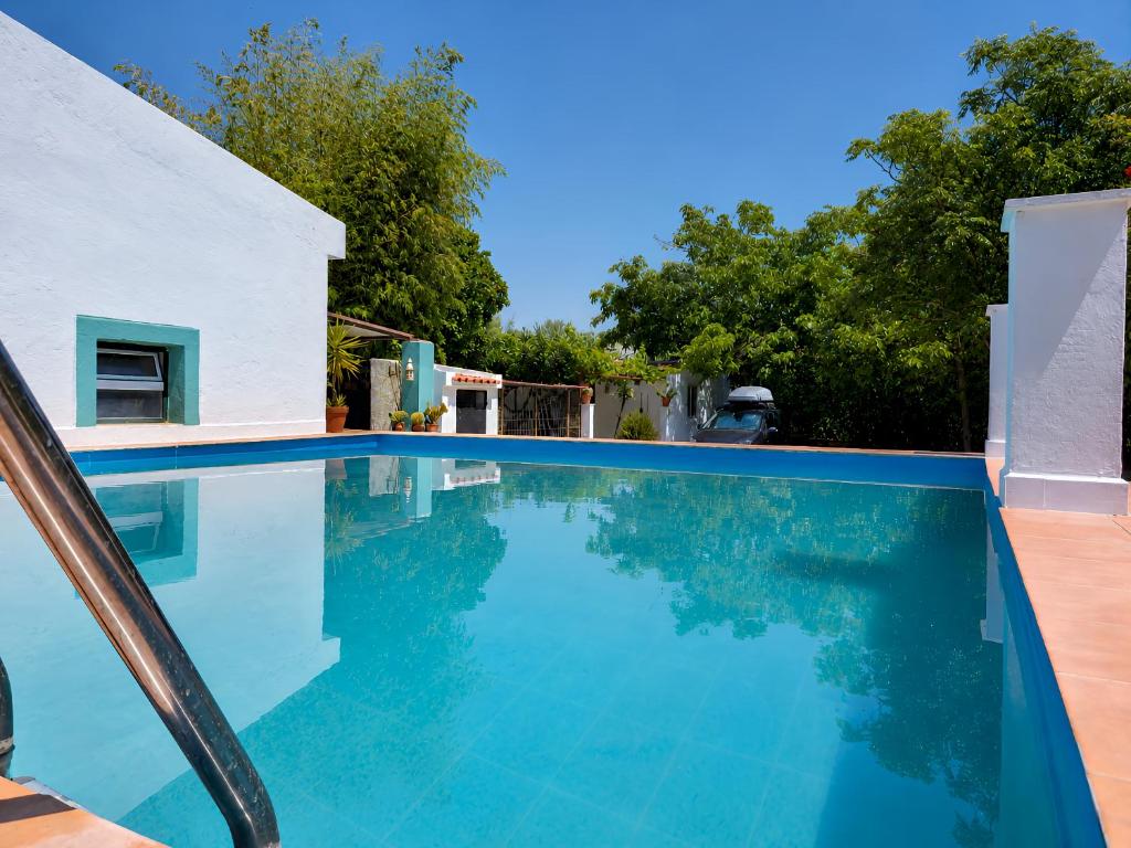 a swimming pool with blue water in a house at Quinta da Ponte das Hortas 2 in Elvas