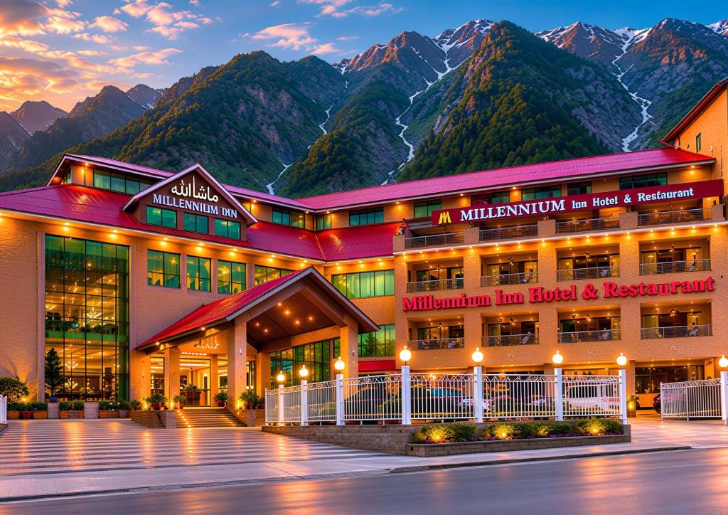 a large building with mountains in the background at Millennium Inn Hotel Naran in Naran