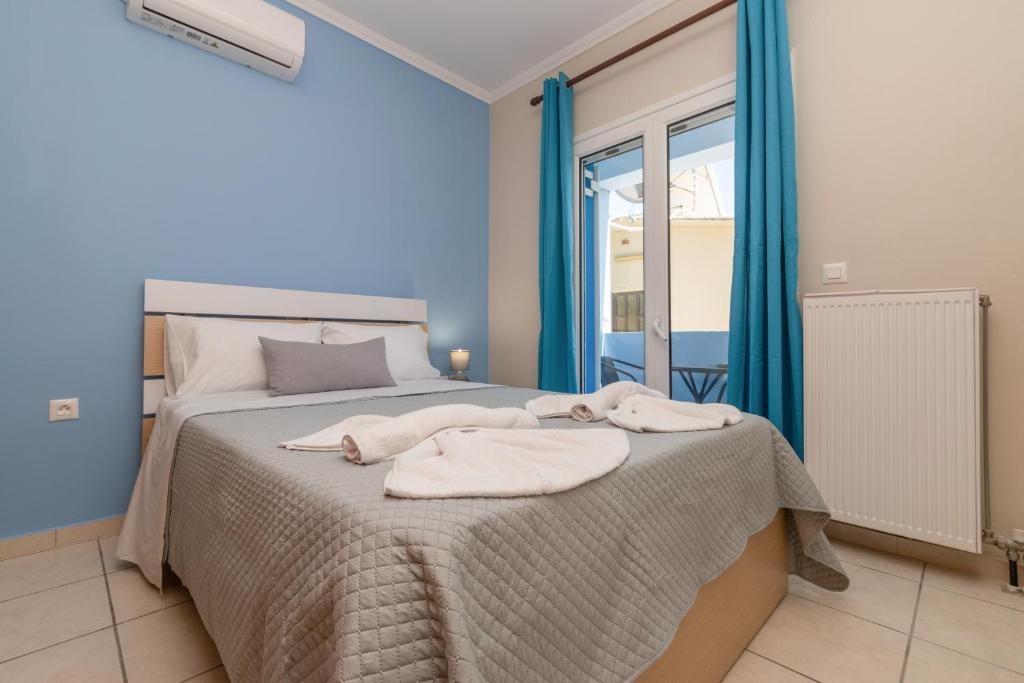 a bedroom with a bed with towels on it at The old inn in Laganas