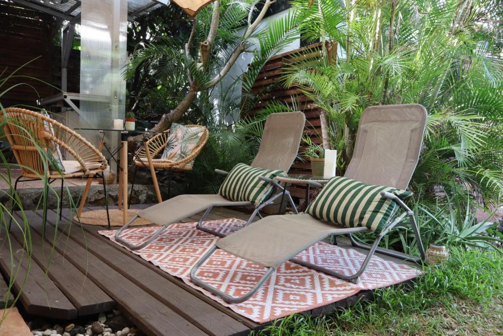 a group of chairs sitting on a porch at Ti Kaz Ravinala in Ravine des Cabris