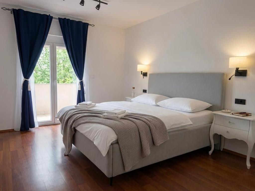 a bedroom with a large bed and a window at Moro Crikva in Crikvenica