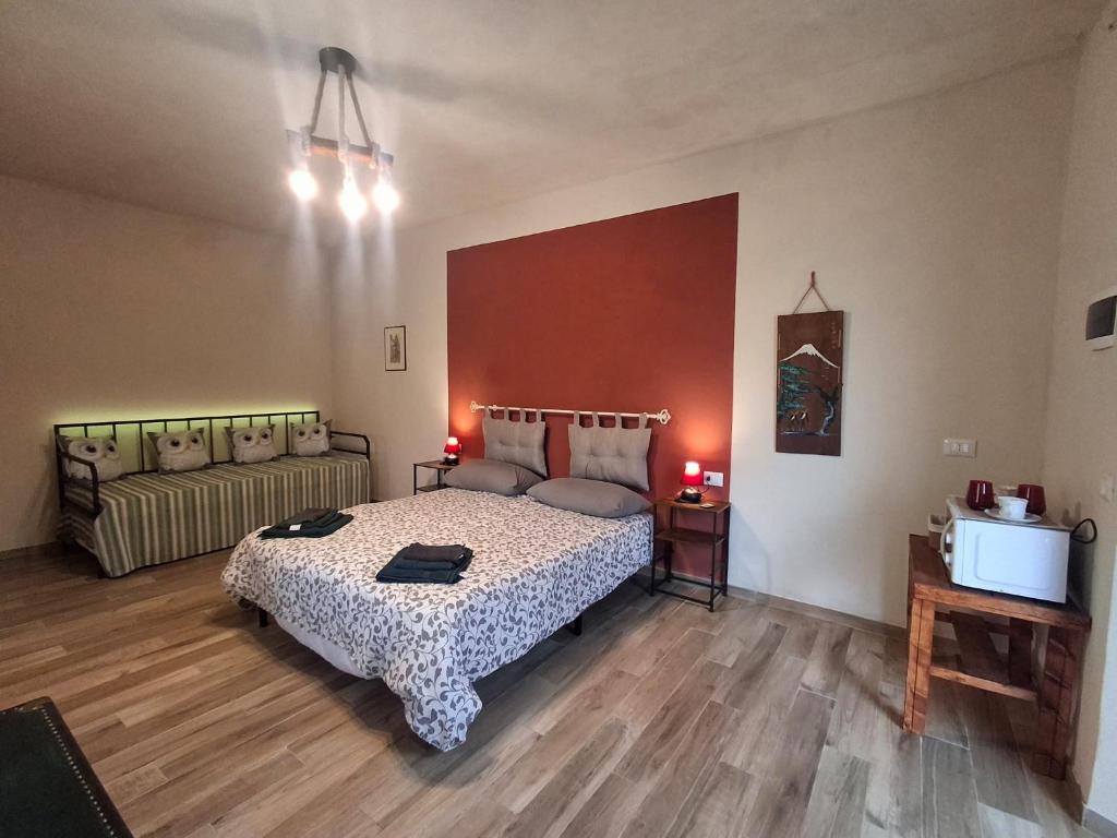 a bedroom with a bed and a couch at Ca' della Civetta in Gavedo