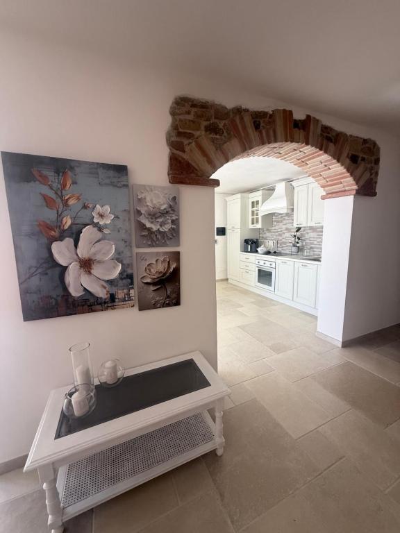 a kitchen with a table in the middle of a room at Relax House Sardara in Sardara