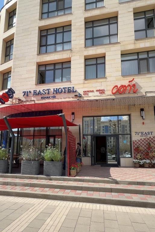 a building with a fast hotel in front of it at 71 East Hotel in Astana