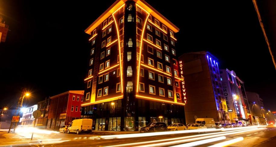 a tall building on a city street at night at Newway Otel in Kayseri