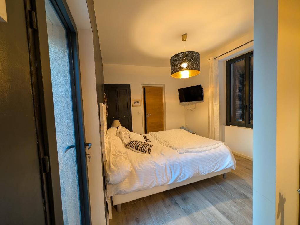 a small bedroom with a bed and a pendant light at Chambre ELENA in La Crau