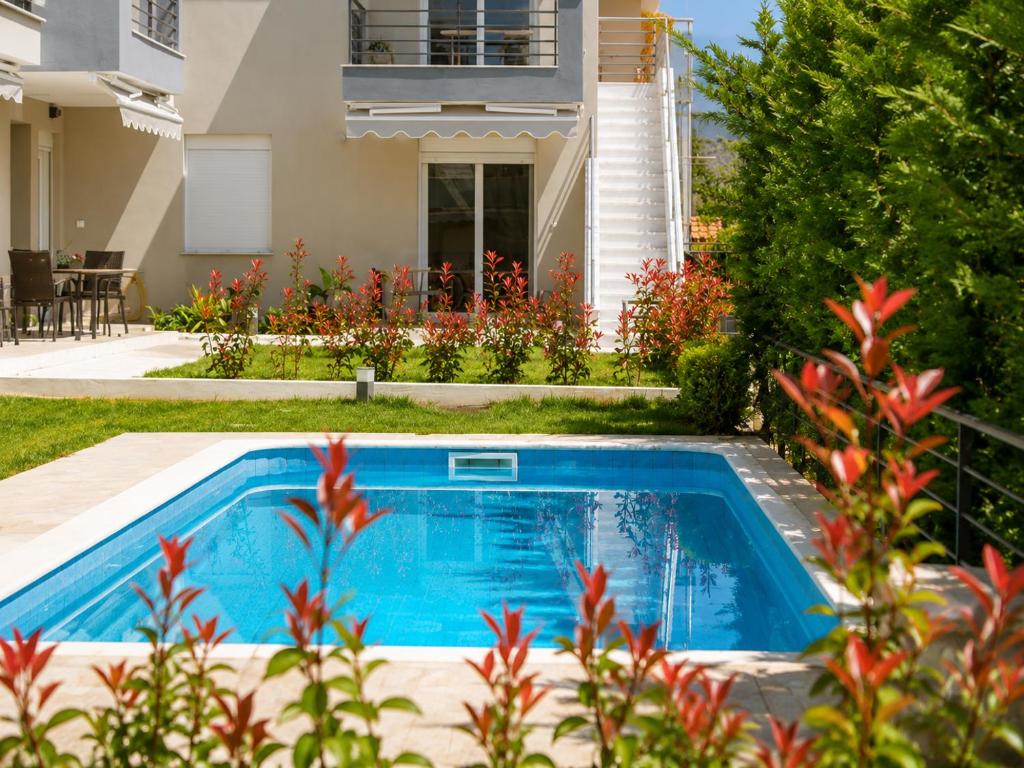 a swimming pool in front of a house at Pool Access Danai 15,1 in Ofrínion
