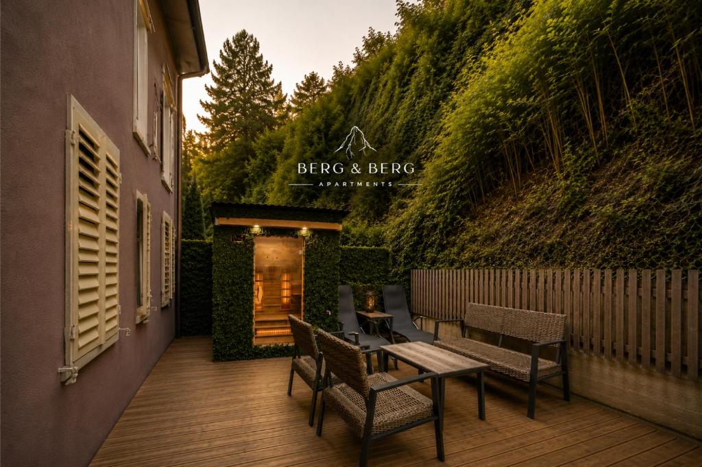 a patio with chairs and a table and a building at BERG & BERG Apartments - Luzern Self-Check-in in Lucerne