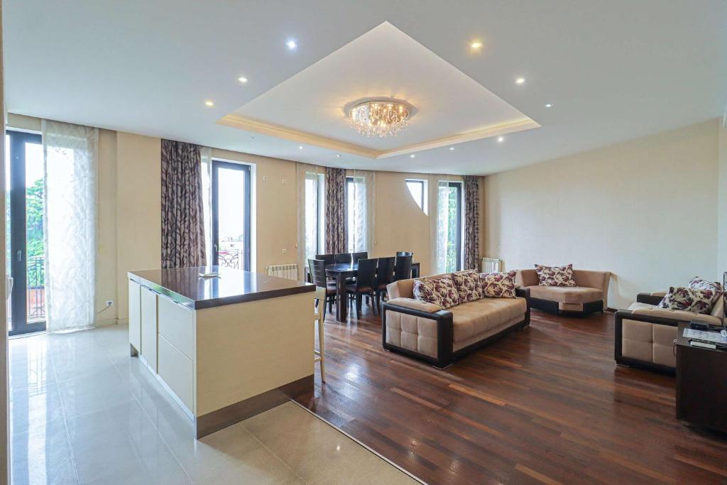 a large living room with a couch and a table at Spacious Sololaki 2BR with Balcony - by Wehost in Tbilisi City