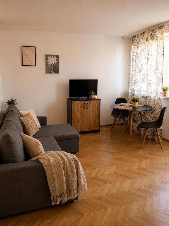 a living room with a couch and a table at Studio Słowackiego in Września