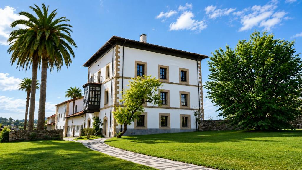 a large white house with palm trees and grass at Tejasturias |Piscina, Pádel y Playa de La Franca in Noriega
