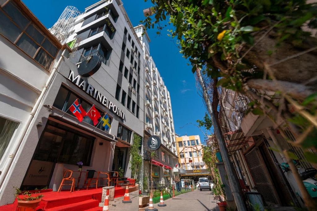 a street with a building with a sign on it at Marine Point Hotel & Antalya in Antalya