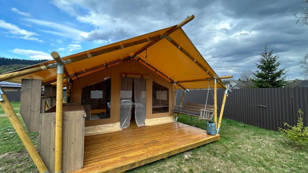 a house with a porch and a deck at Prozori Boiky in Lopushanka-Khomyna