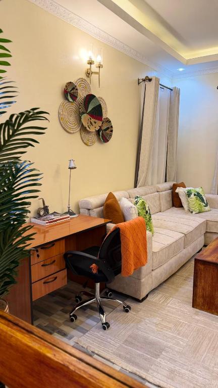 a living room with a desk and a couch at Serenity Elgon Stay in Eldoret